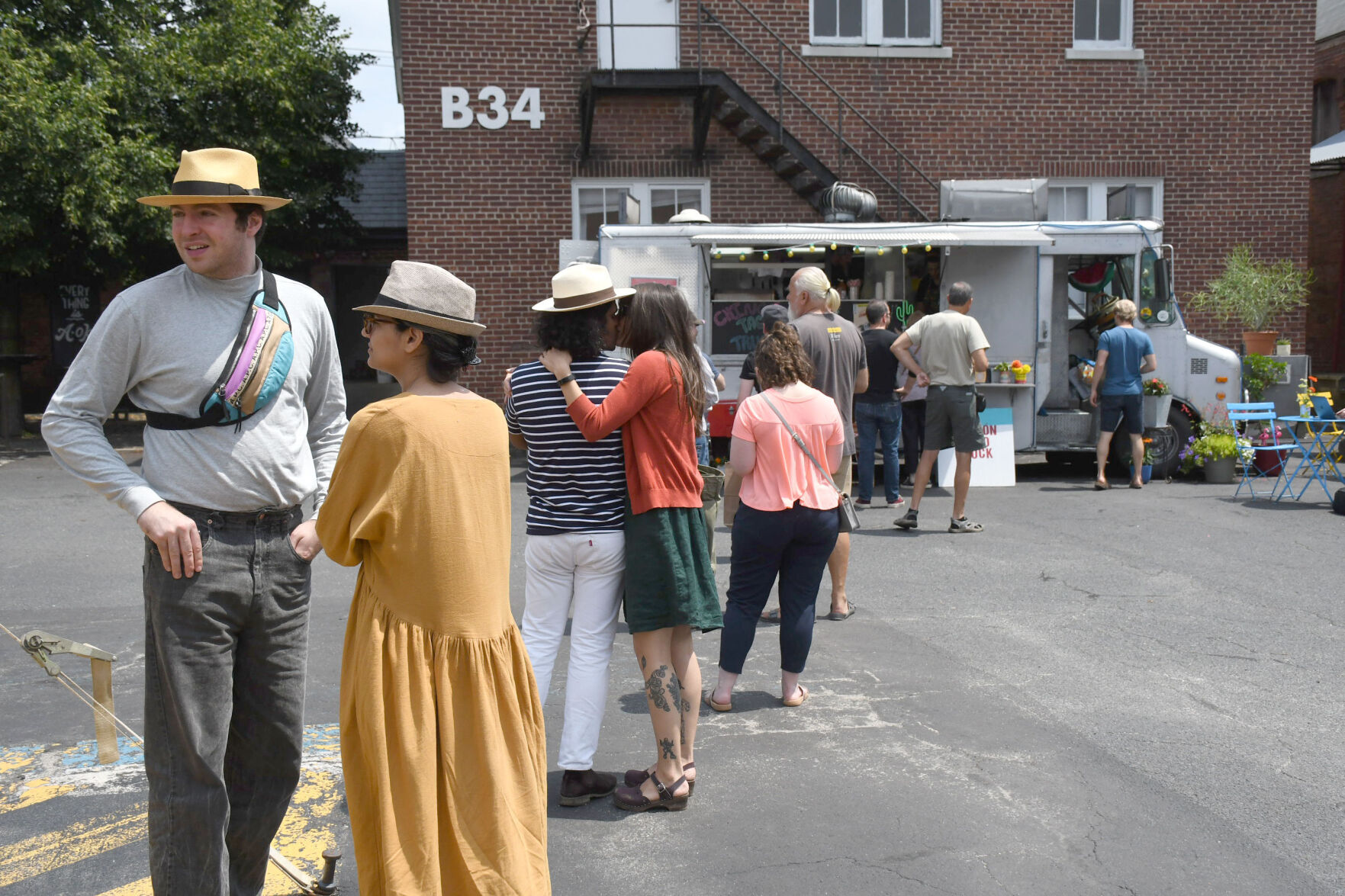 About a dozen people stand outside of Chingòn Taco Truck